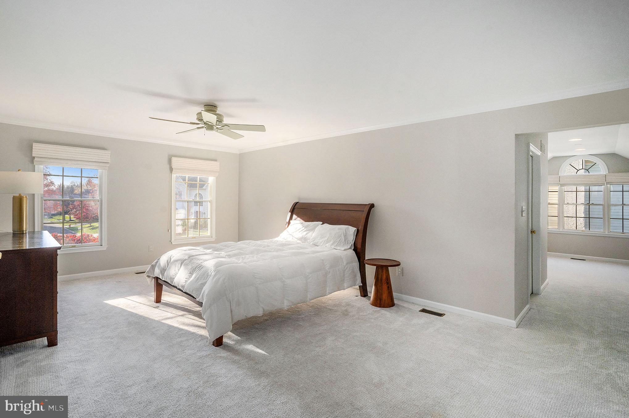 127 Spyglass Drive Blue Bell, PA 19422 - Photo 21 of 74 a large bed sitting in a bedroom next to a window with lamp