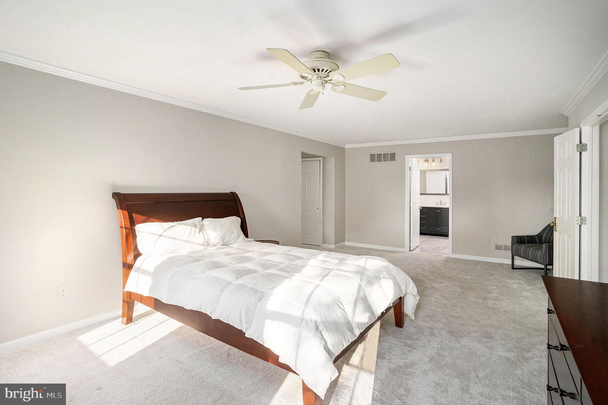 127 Spyglass Drive Blue Bell, PA 19422 - Photo 22 of 74 a bedroom with a bed and a chandelier