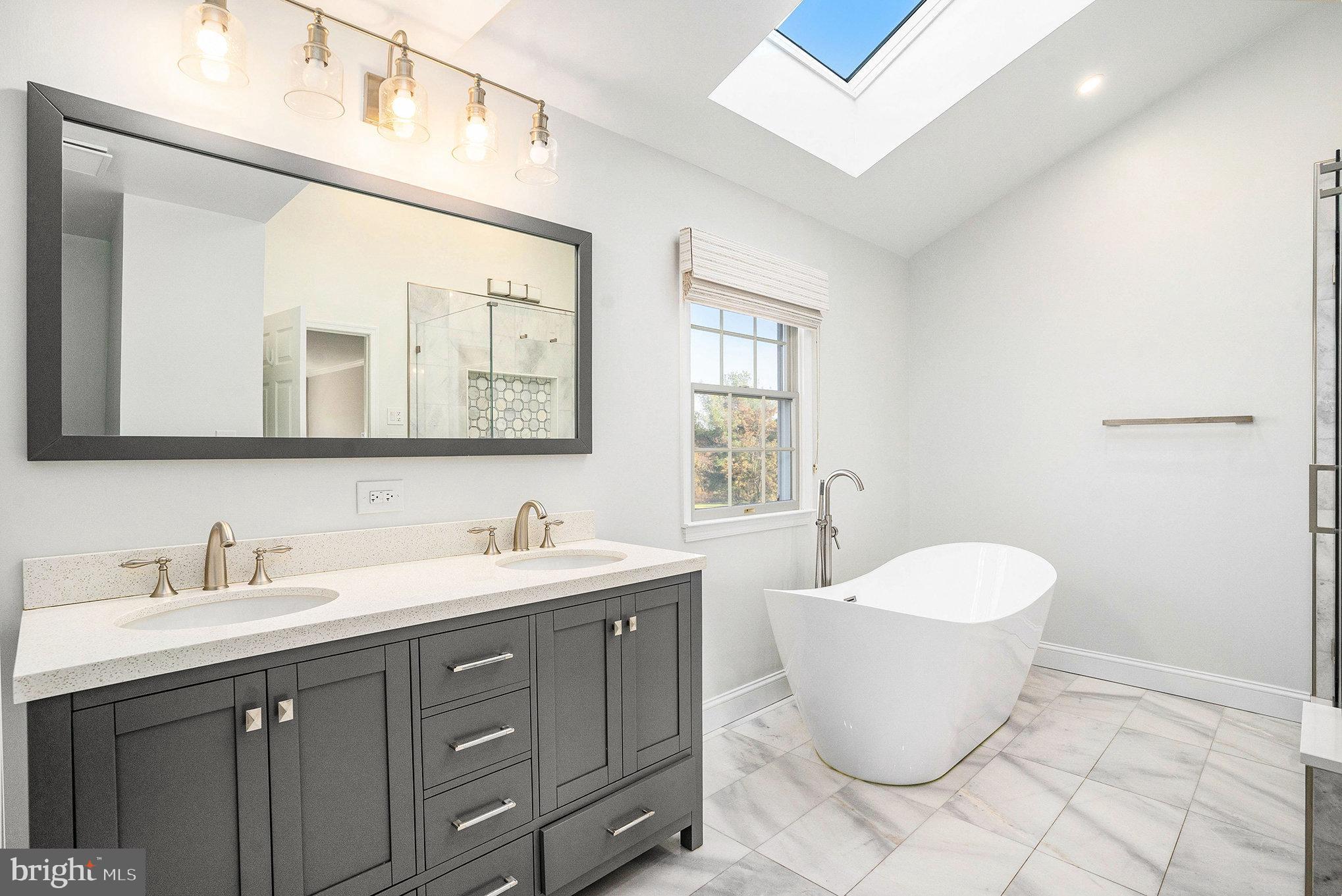 127 Spyglass Drive Blue Bell, PA 19422 - Photo 24 of 74 a spacious bathroom with a double vanity sink a mirror and a bathtub