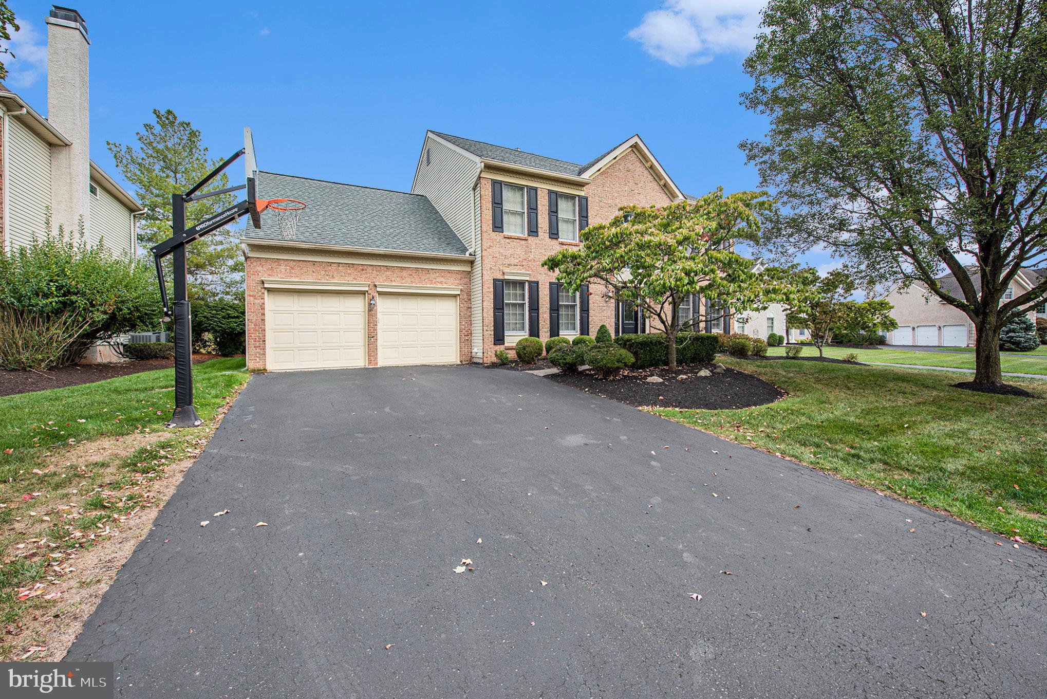 127 Spyglass Drive Blue Bell, PA 19422 - Photo 3 of 74 a front view of a house with a yard and garage