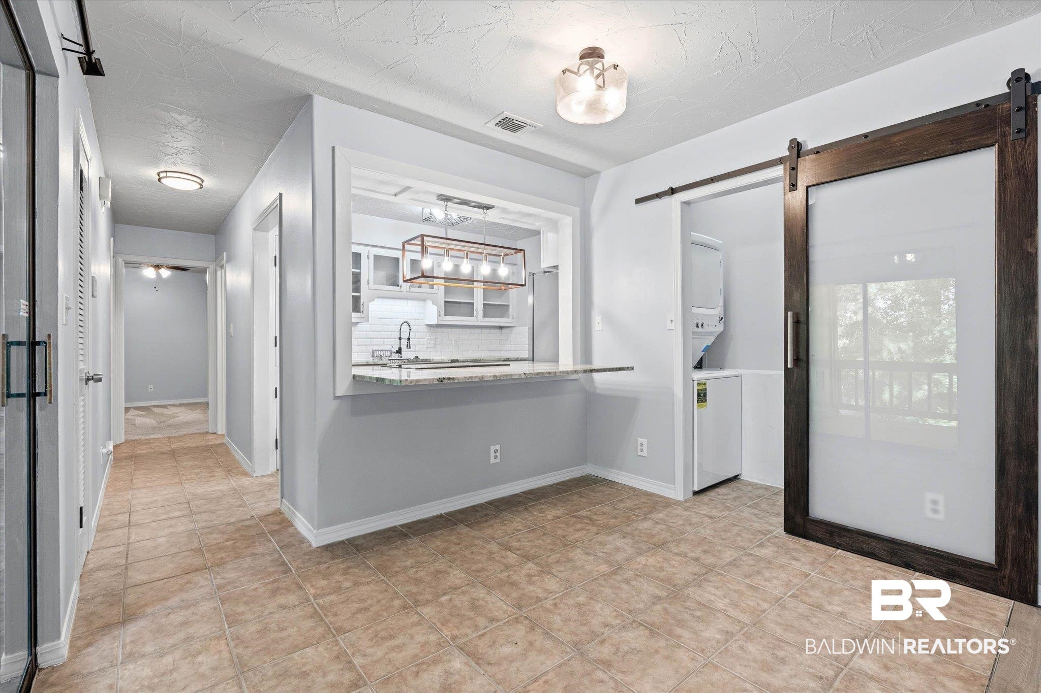 500 Grant Street, Unit C210 Daphne, AL 36526 - Photo 8 of 26 Open-concept living space featuring tile flooring and light gray walls