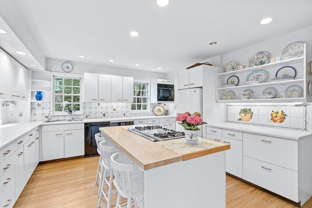 218 Middlesex Road Brookline, MA 02467 - Photo 12 of 30 a kitchen with granite countertop a sink stove and cabinets