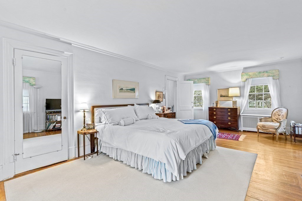 218 Middlesex Road Brookline, MA 02467 - Photo 18 of 30 a bedroom with a large bed and wooden floor