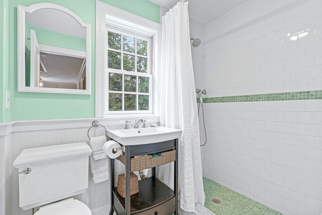 218 Middlesex Road Brookline, MA 02467 - Photo 20 of 30 a bathroom with a sink a toilet and a mirror