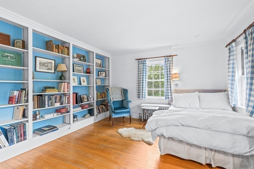 218 Middlesex Road Brookline, MA 02467 - Photo 22 of 30 a bedroom with a bed and a book shelf