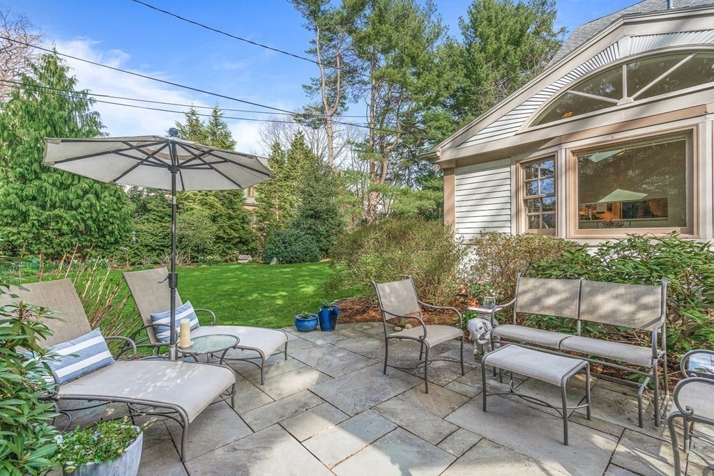 218 Middlesex Road Brookline, MA 02467 - Photo 27 of 30 a view of a patio with a table and chairs under an umbrella