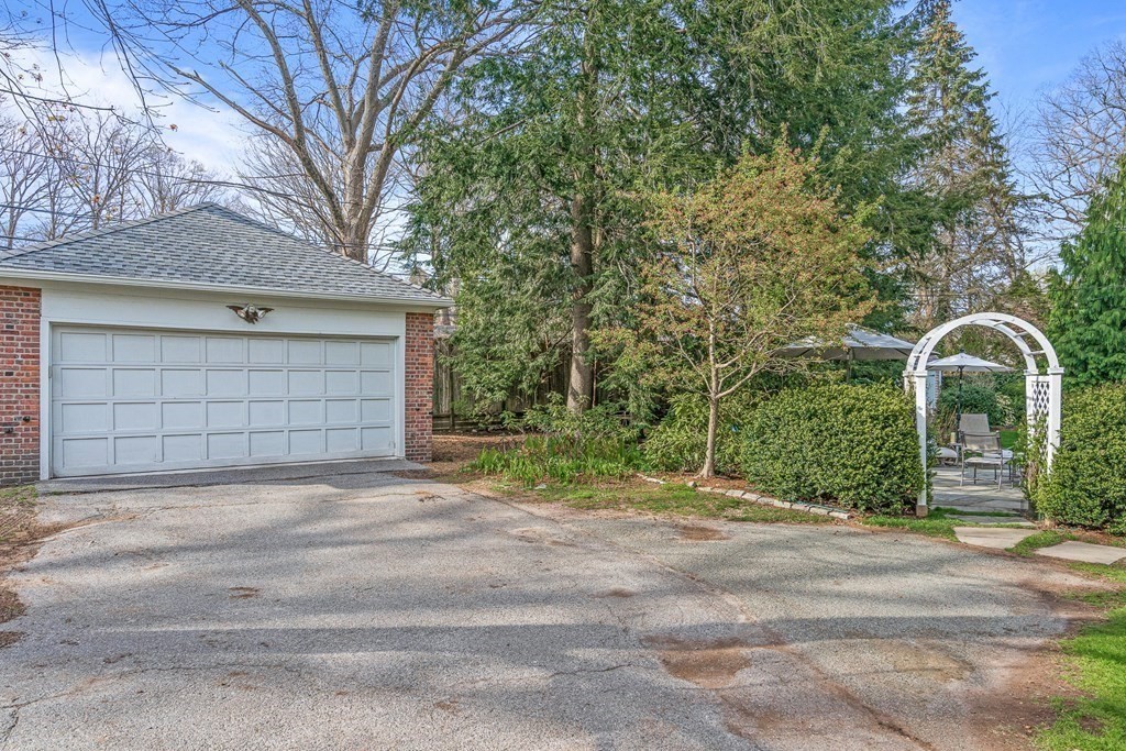 218 Middlesex Road Brookline, MA 02467 - Photo 30 of 30 a backyard of a house with large trees and plants