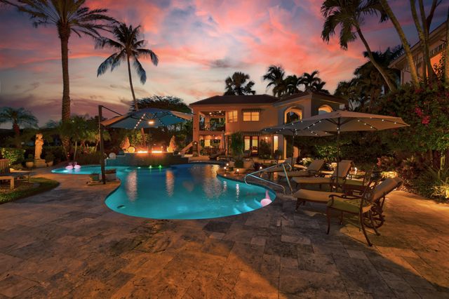 an aerial view of a house with garden space and swimming pool