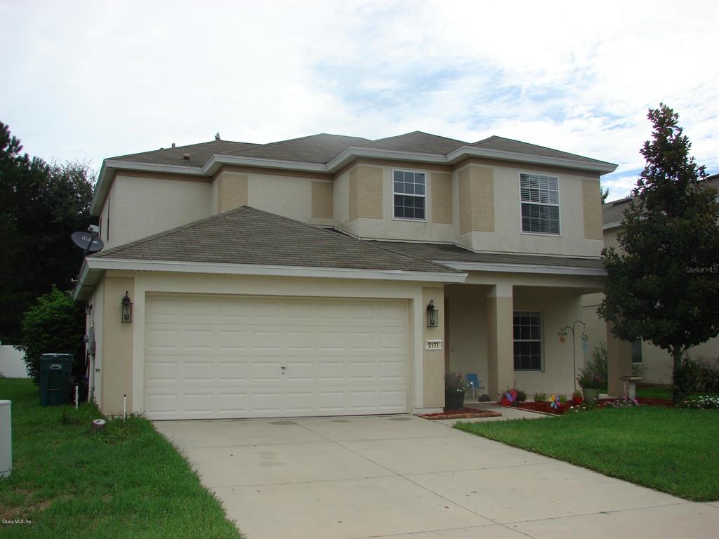 5171 Southwest 39th Street Ocala, FL 34474 - Photo 1 of 1 a front view of a house with a garden and garage