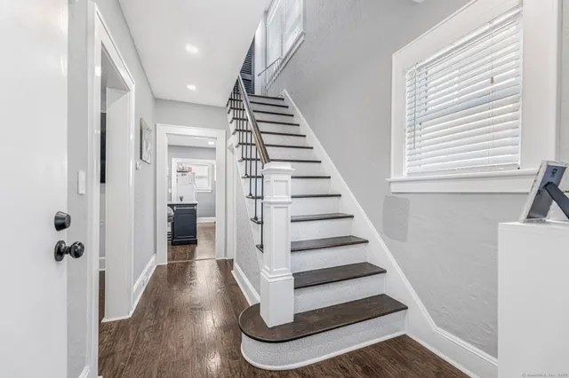 a view of entryway and hall with wooden floor