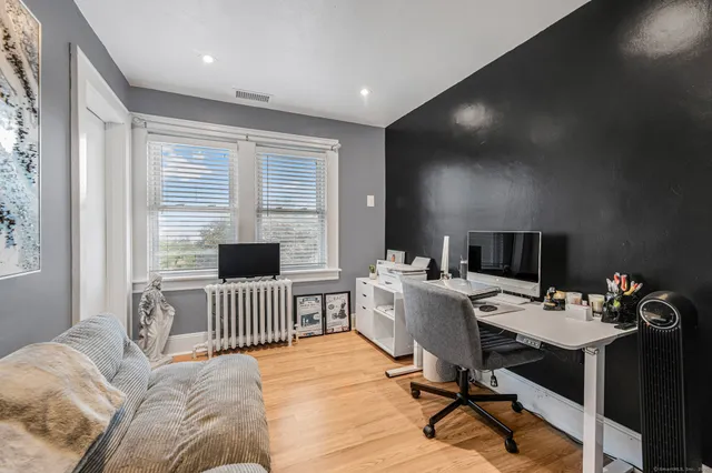 a workspace with furniture hardwood and a window