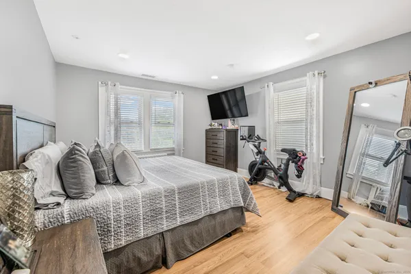 a bedroom with bed and a flat tv screen