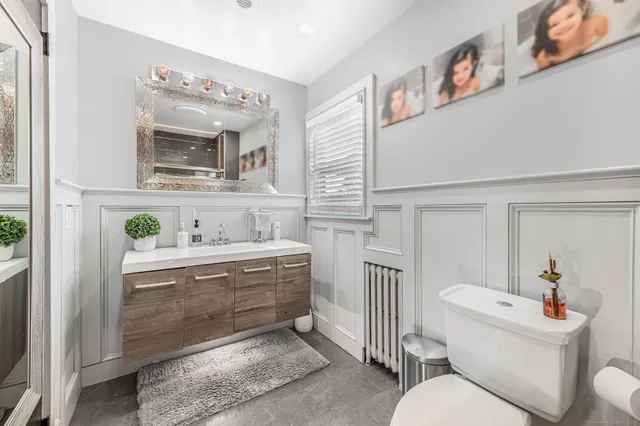 a living room with furniture and a mirror