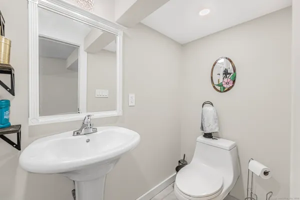 a bathroom with a toilet a sink and a mirror