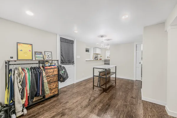 a view of a room with furniture and wooden floor