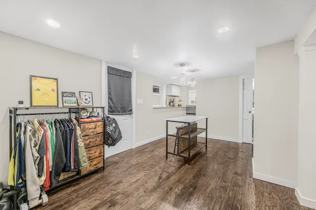 a view of a room with furniture and wooden floor