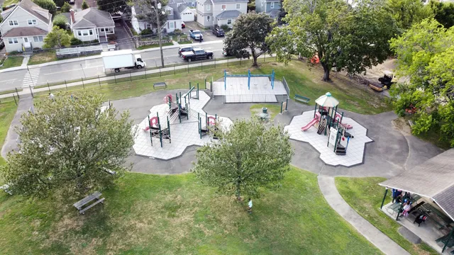 an aerial view of a house with swimming pool a yard and a fountain