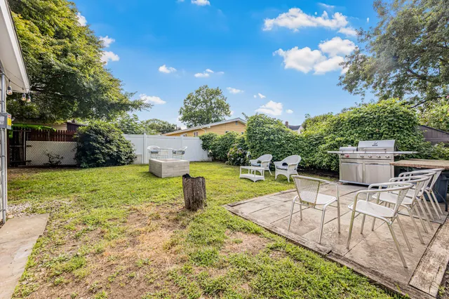 a view of a backyard with sitting area