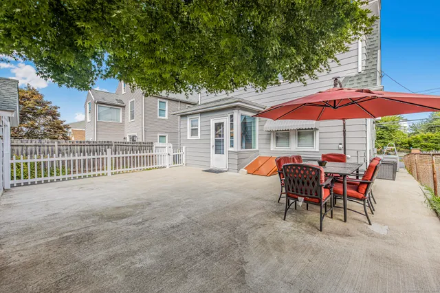 a view of a house with backyard and sitting area