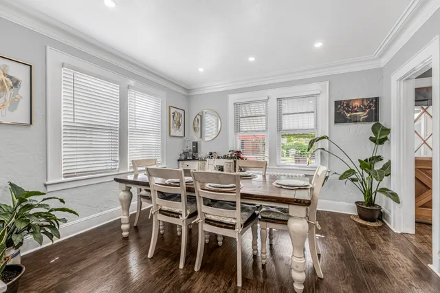 a view of a dining room with furniture and wooden floor