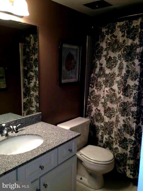 10 Cross Keys Road Baltimore, MD 21210 - Photo 11 of 14 a bathroom with a granite countertop toilet and a sink