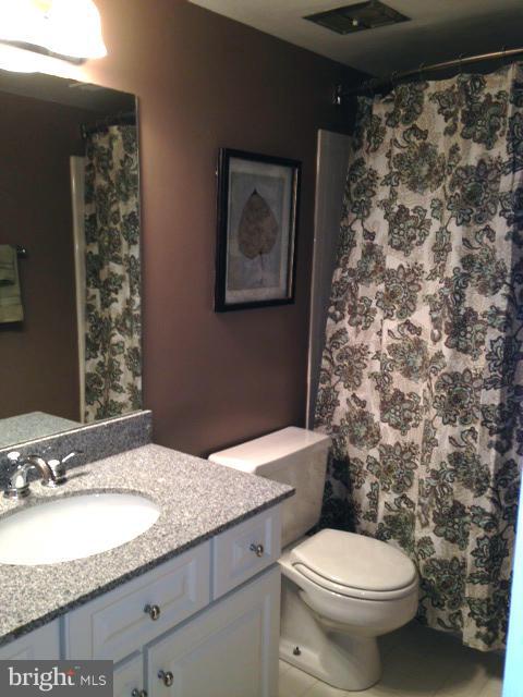 10 Cross Keys Road Baltimore, MD 21210 - Photo 12 of 14 a bathroom with a granite countertop toilet sink and mirror