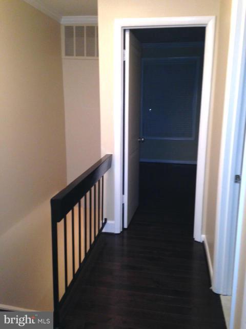10 Cross Keys Road Baltimore, MD 21210 - Photo 13 of 14 a view of a hallway with wooden floor