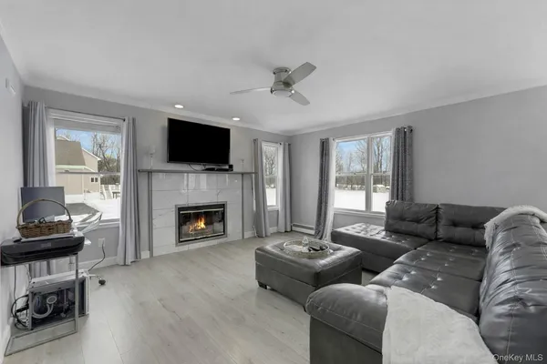 a living room with furniture a flat screen tv and a fireplace