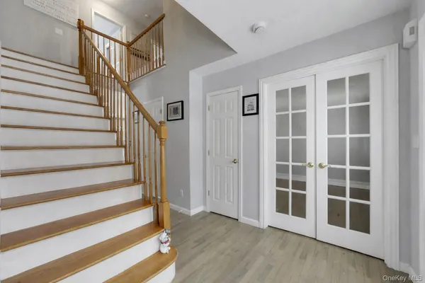 a view of front door with wooden floor and windows