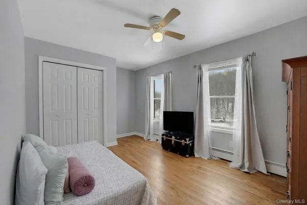a bed room with a bed and a television