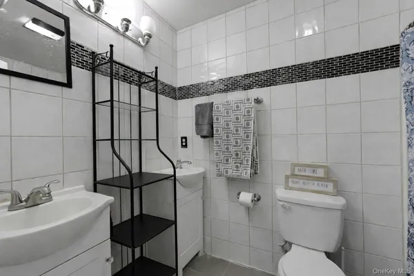 a bathroom with a toilet sink and shower