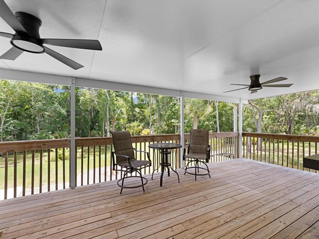 5904 Springrun Court Holiday, FL 34690 - Photo 5 of 53 a view of a patio with a table chairs and wooden floor