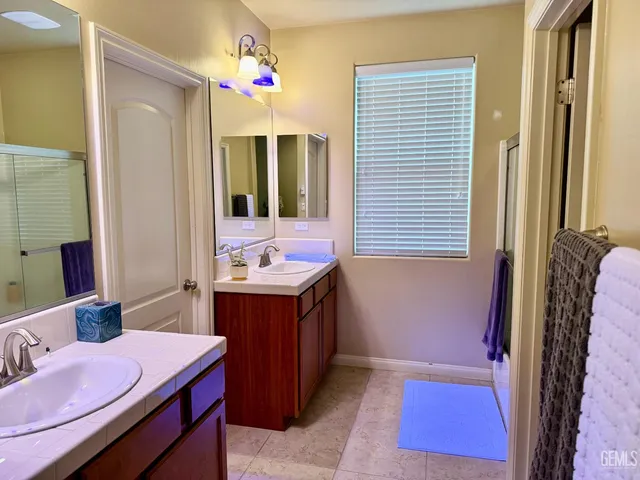 a bathroom with a sink a mirror and a bathtub