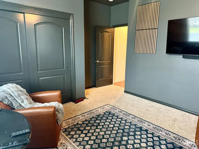 a bedroom with a bed and flat screen tv