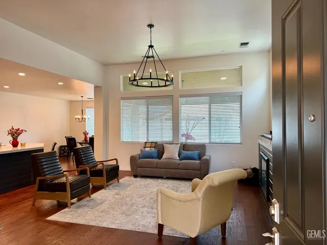 a living room with furniture and a chandelier
