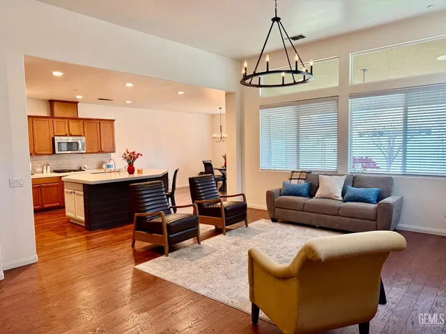 a living room with furniture and a chandelier