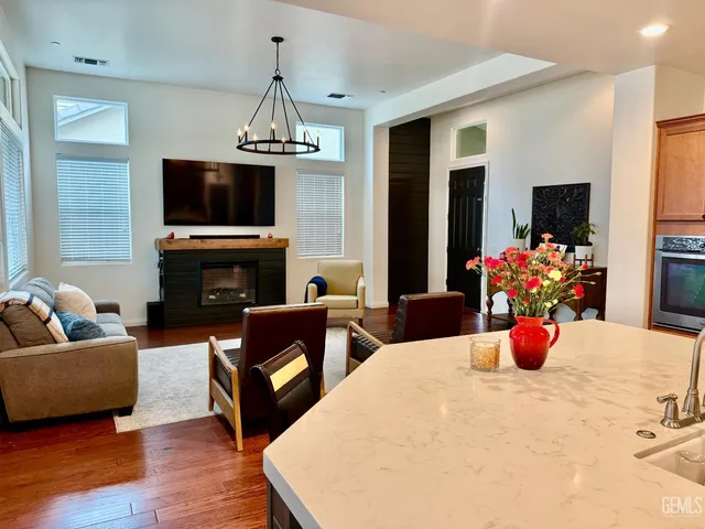 a living room with furniture fireplace and flat screen tv