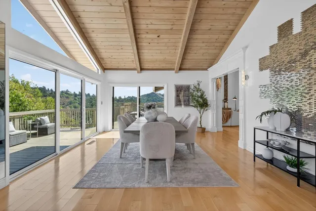 a dining room with furniture wooden floor and a potted plant