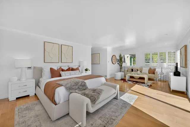 a living room with furniture and a mirror