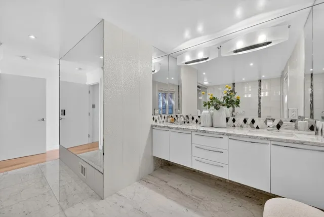 a bathroom with a granite countertop sink a toilet and shower
