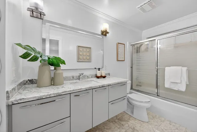 a bathroom with a sink toilet and mirror