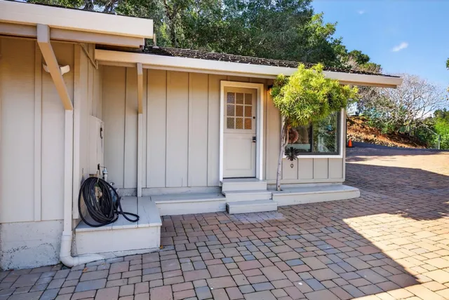 a view of house with outdoor space and sitting area