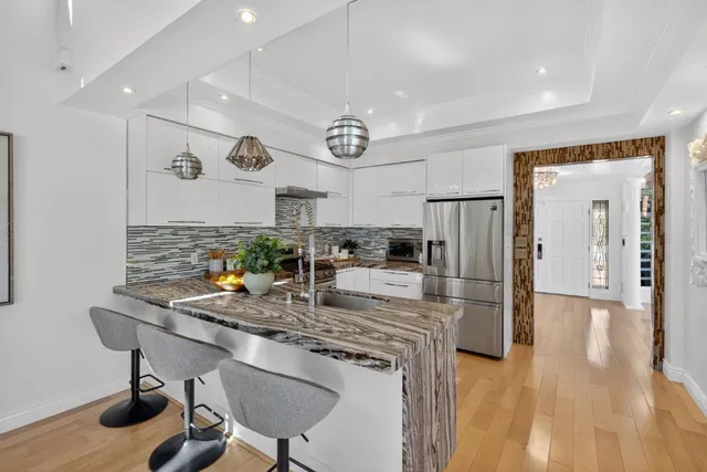 a kitchen with center island cabinets and stainless steel appliances