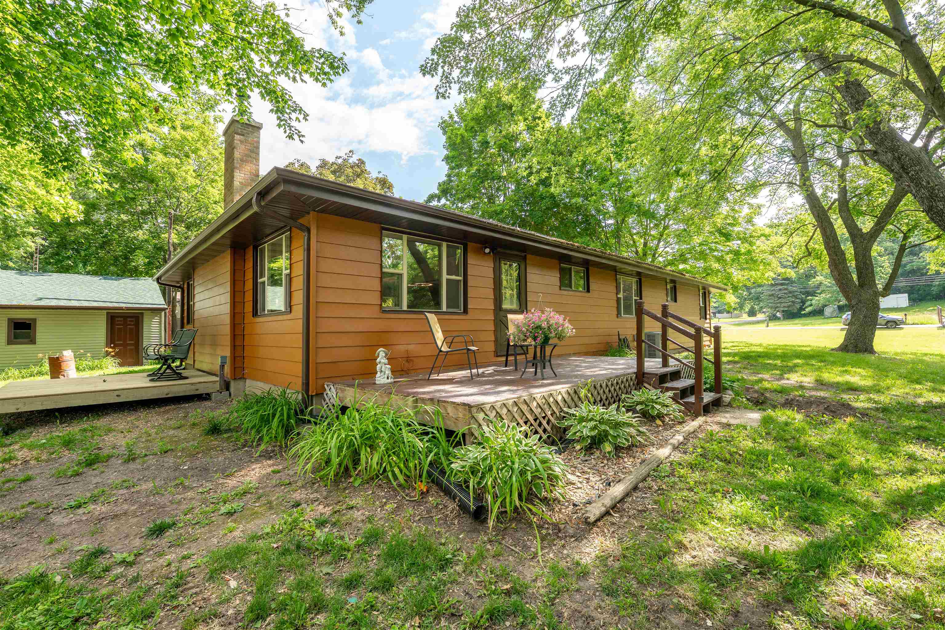 a view of a house with backyard and sitting area