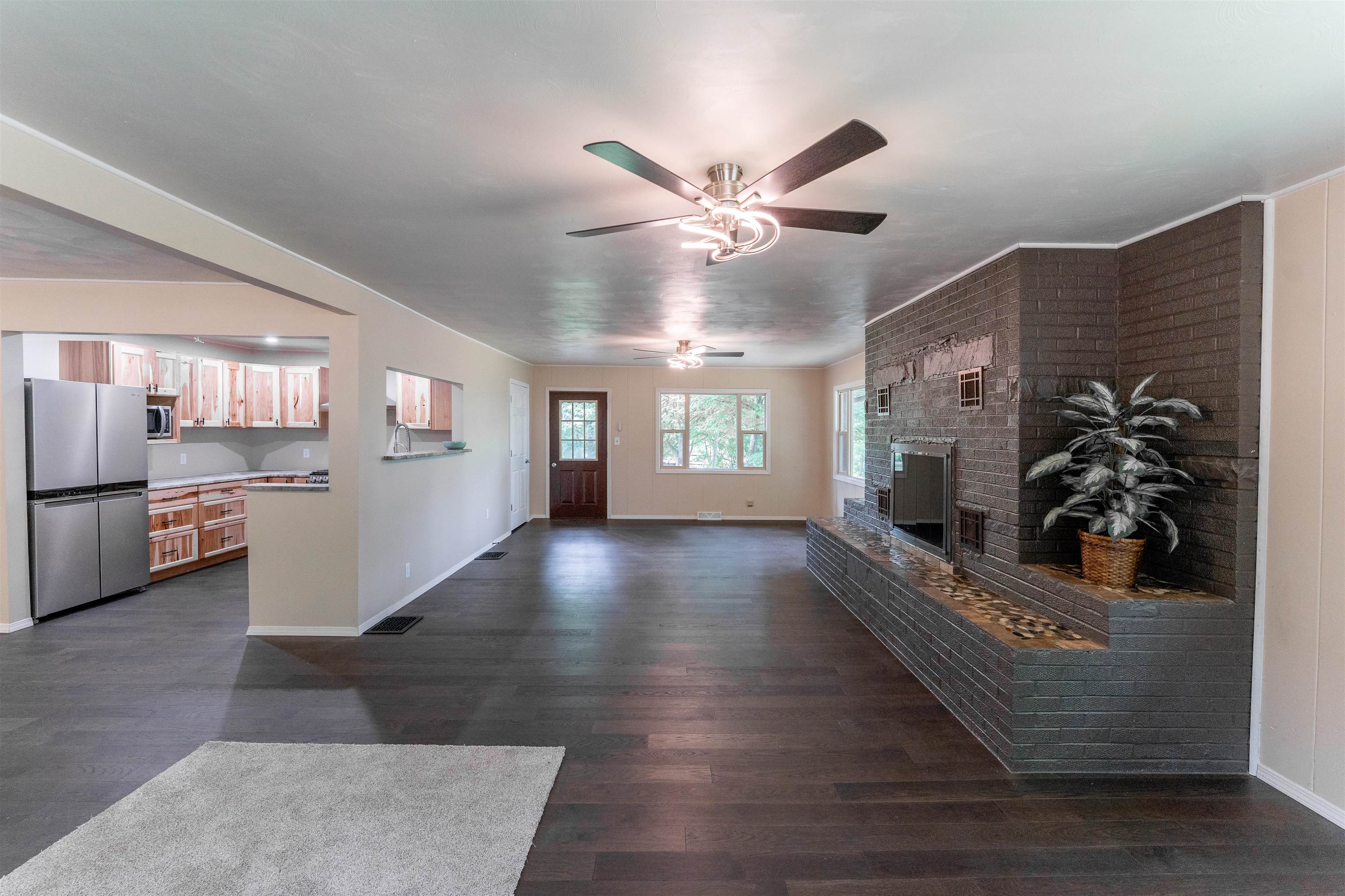 1162 South Bradley Road Oregon, IL 61061 - Photo 14 of 78 a view of a living room and kitchen with furniture a ceiling fan and wooden floor
