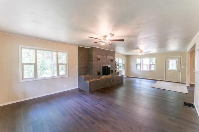 a kitchen with kitchen island granite countertop a sink and cabinets