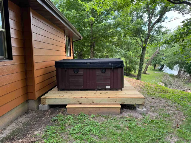 an aerial view of a house with a lush green forest