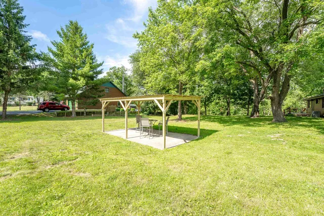 an aerial view of a house with a yard and lake view