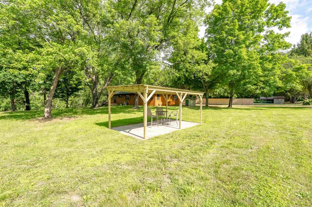 an aerial view of residential houses with outdoor space and lake view