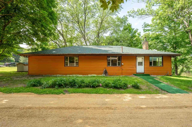 a view of a backyard with a large tree